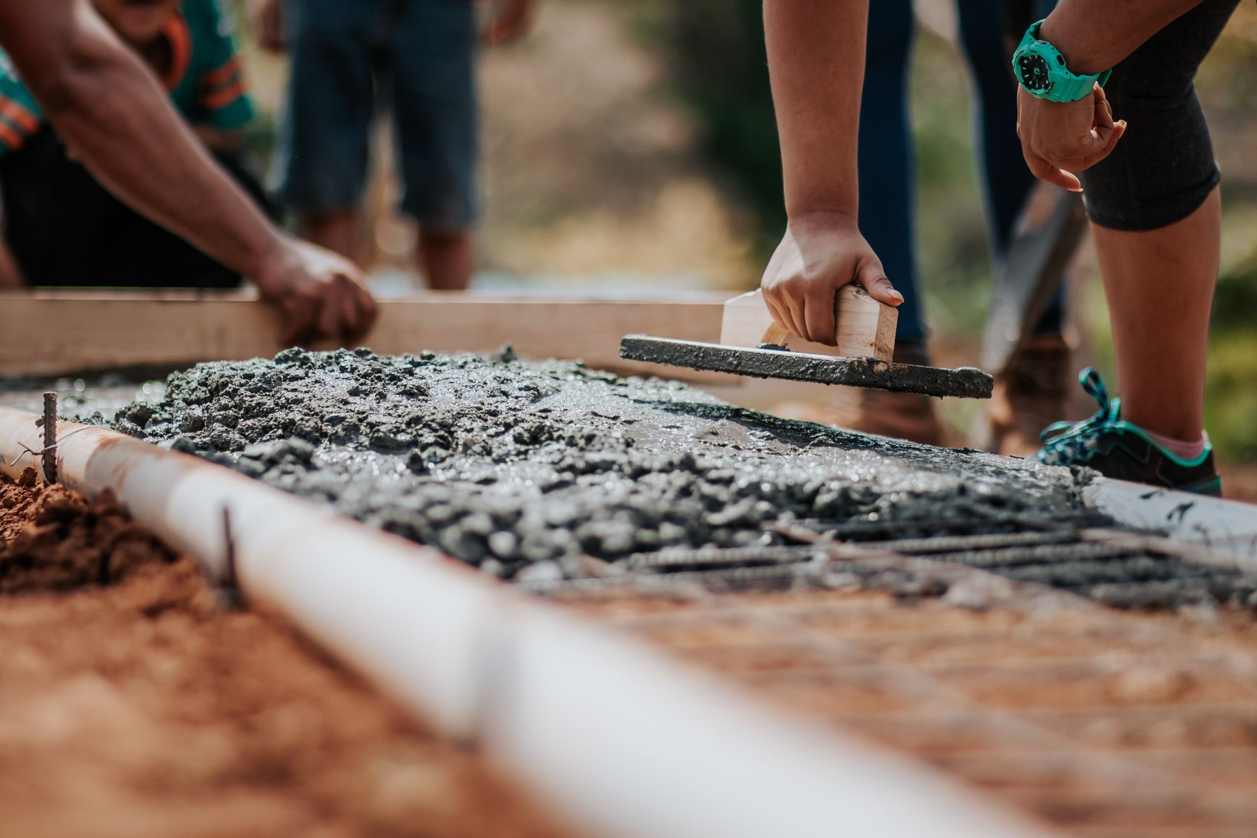 Concrete being leveled by hand